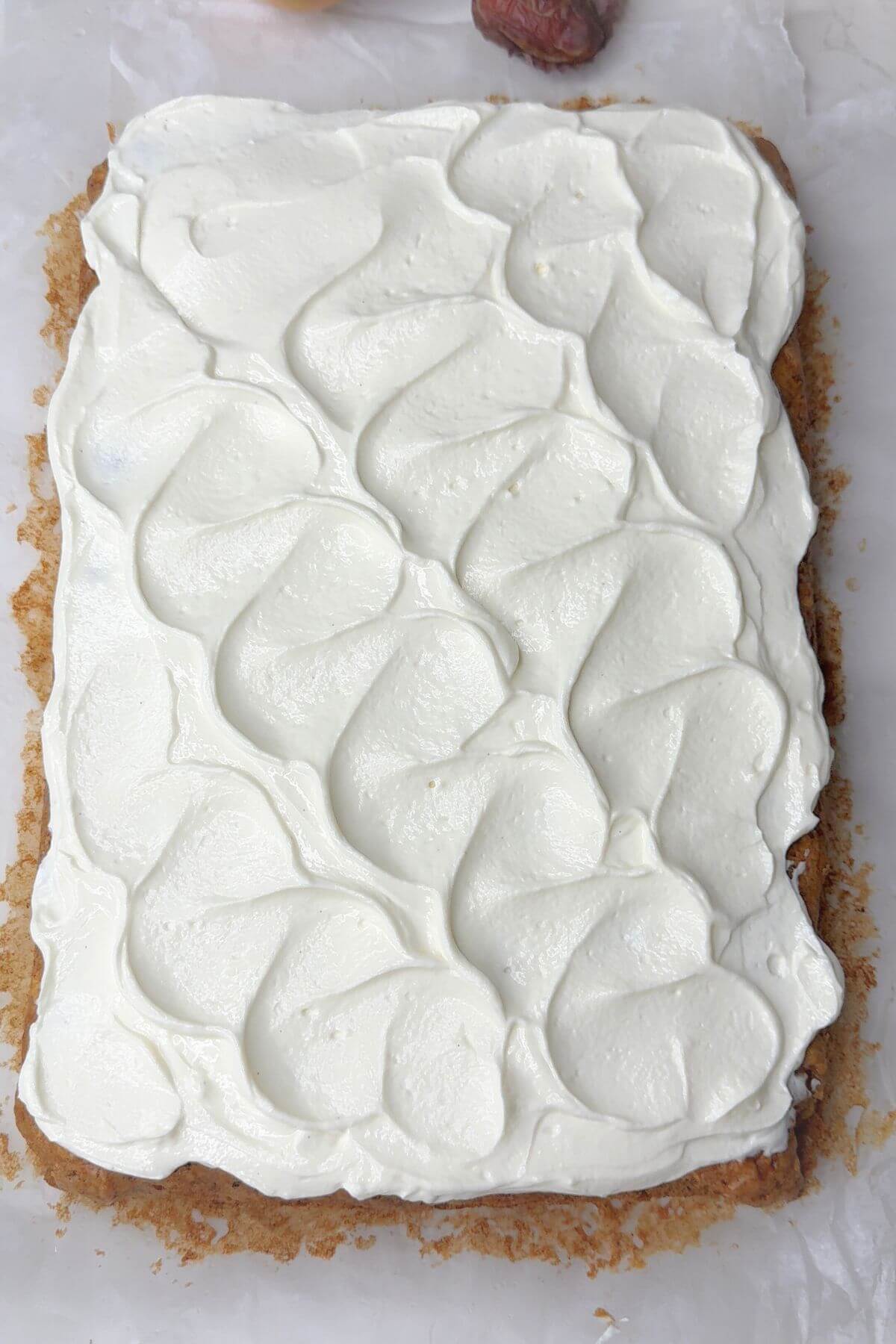 Healthy Greek yogurt cream cheese frosting on a slice of moist caramel apple cake.