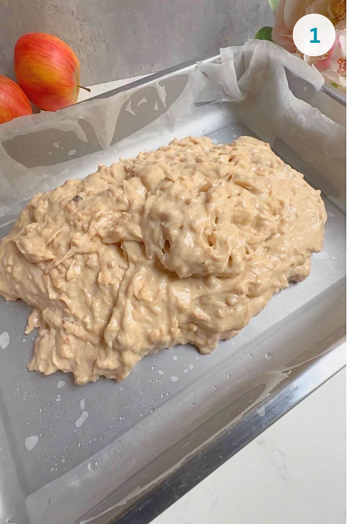 Batter poured into a lined baking pan, ready for baking.