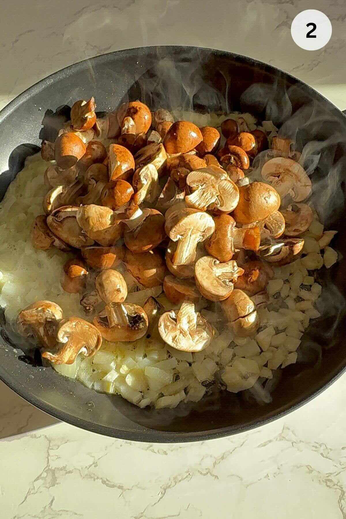Fresh mushrooms washed until water runs clear, drained and halved on wooden cutting board.