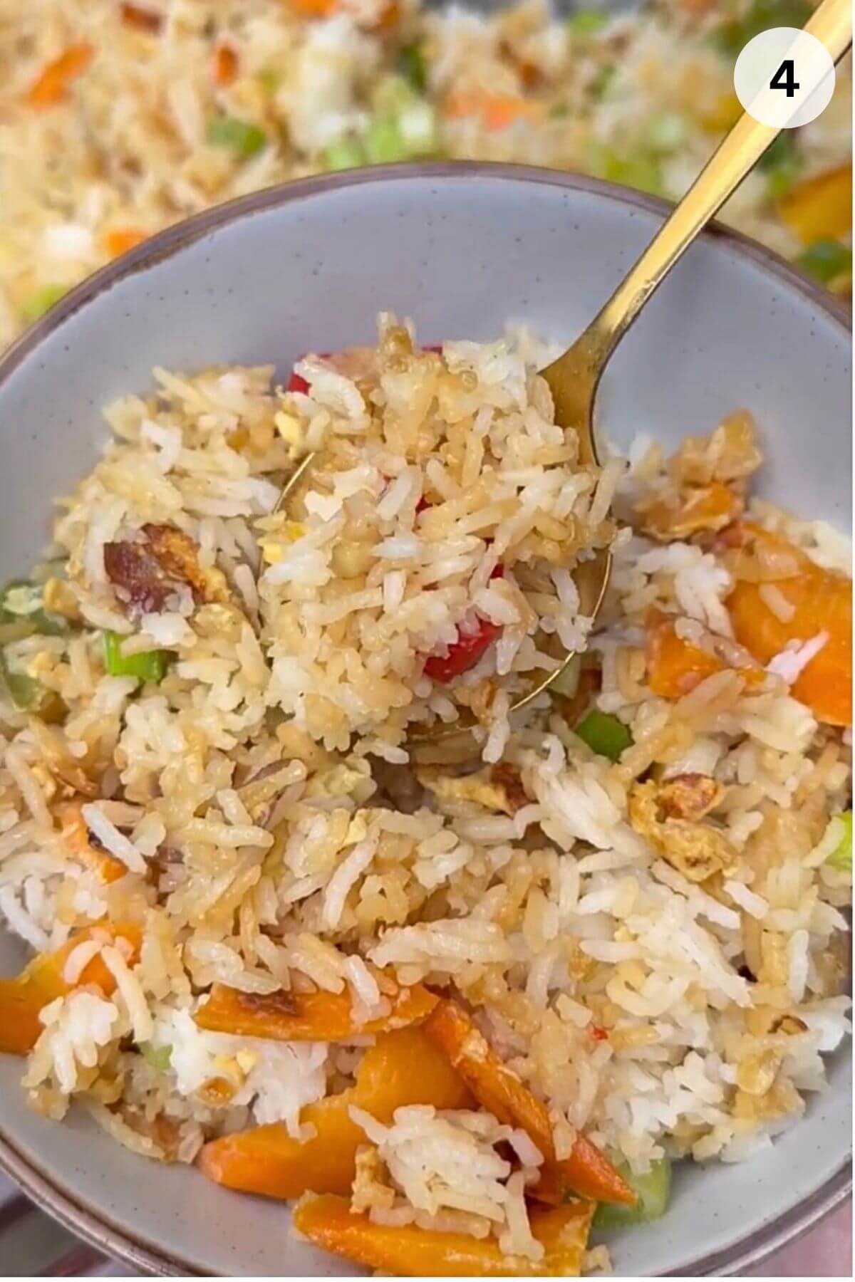 Healthy fried rice with frozen vegetables garnished with green onions in bowl.