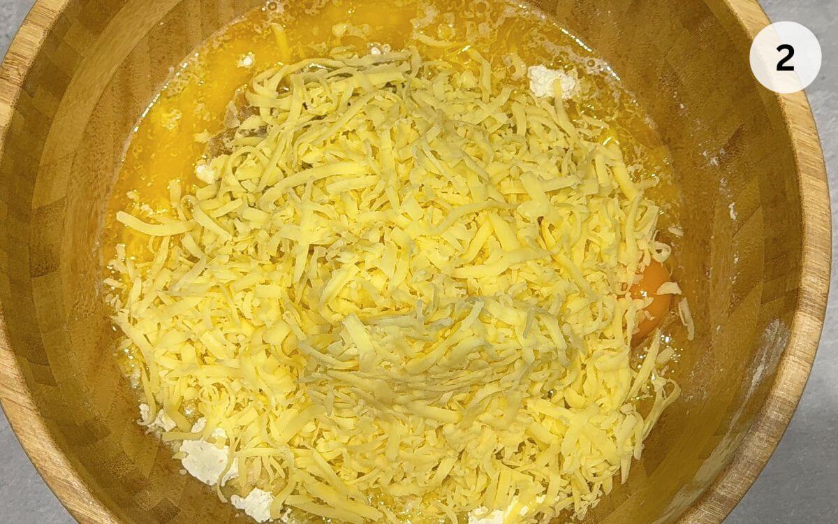Add grated cheese and knead the dough until smooth and firm.
