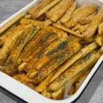 Cheese sticks (saratele) golden, crisp, and lightly puffed on a tray.