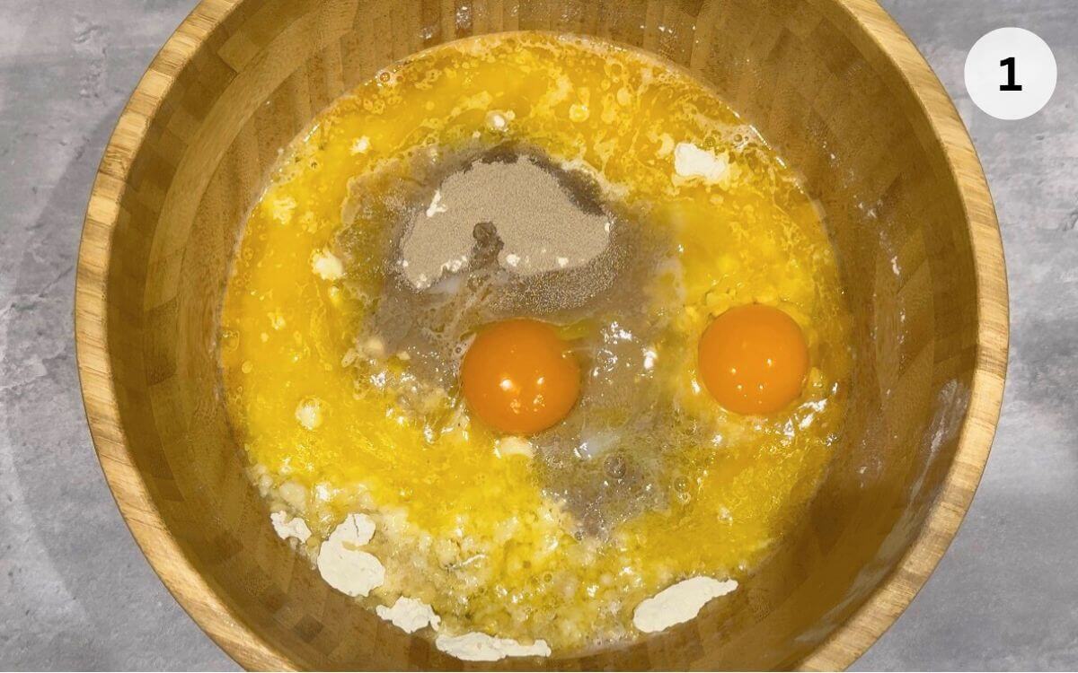 Add flour, salt, yeast, egg, and warm melted butter in a bowl.