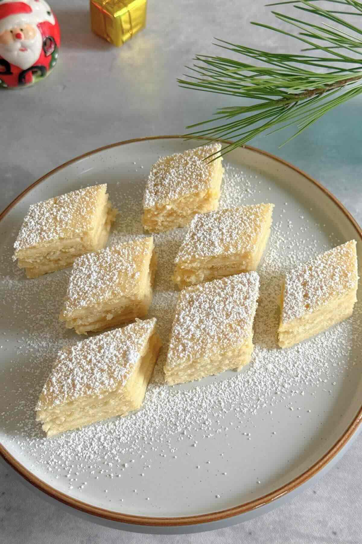 Romanian lemon cream cake with four pastry layers and custard filling.