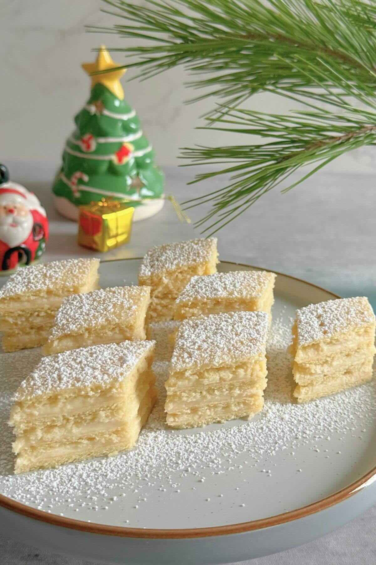 Romanian lemon cream cake with four pastry layers and custard filling.