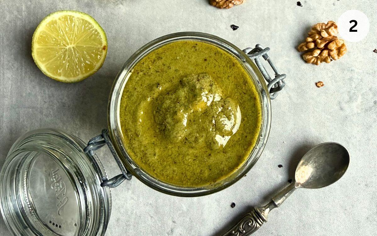 Smooth Thai basil pesto with olive oil, soy sauce, and lime, ready in a jar.