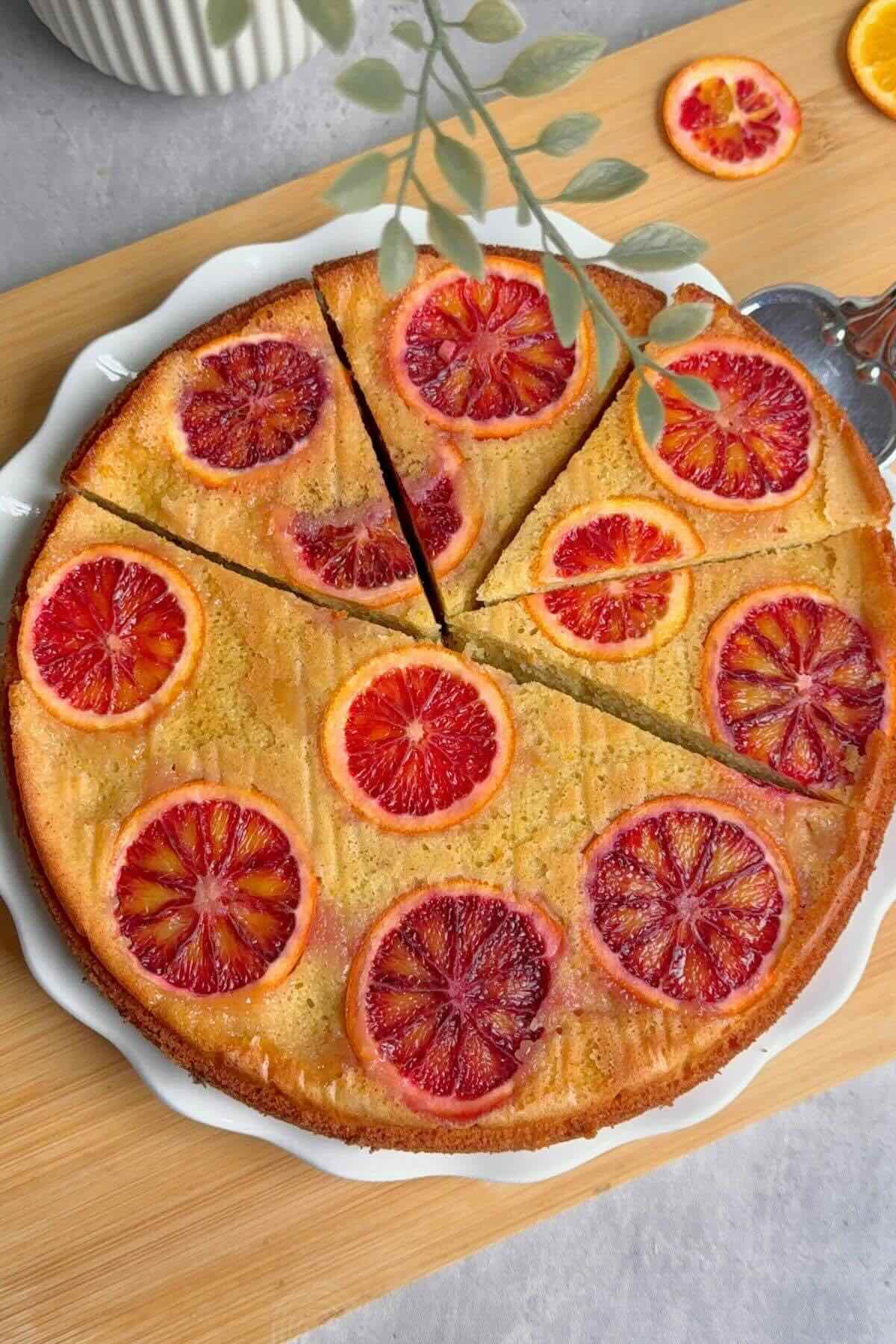 Easy blood orange upside down cake on a white plate with caramelized orange slices.