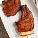 Juicy thick pork chops in air fryer with brown sugar spice rub, bone-in.