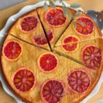 Easy blood orange upside down cake on a white plate with caramelized orange slices.