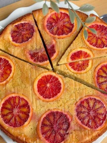 Easy blood orange upside down cake on a white plate with caramelized orange slices.