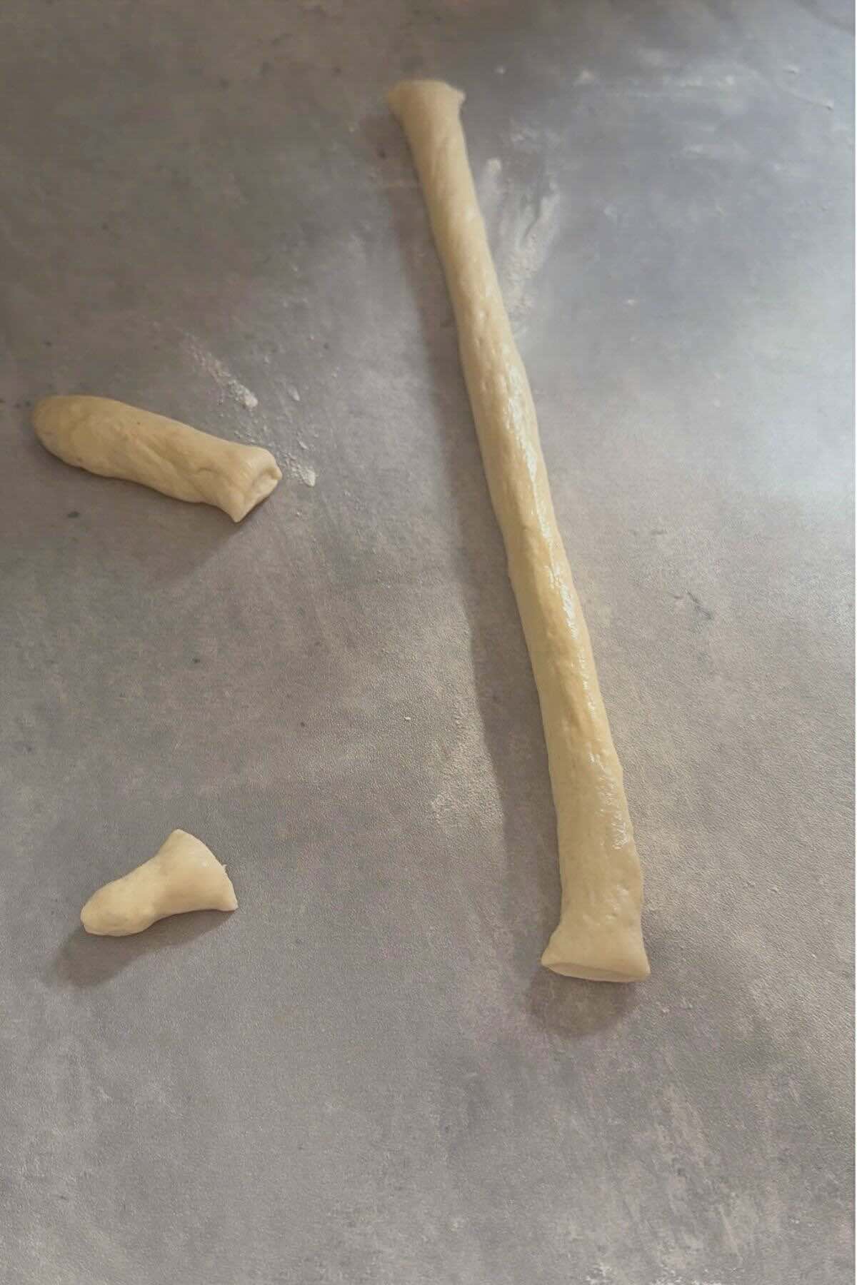 Dough rope cut with one short end for tail and longer end for head.