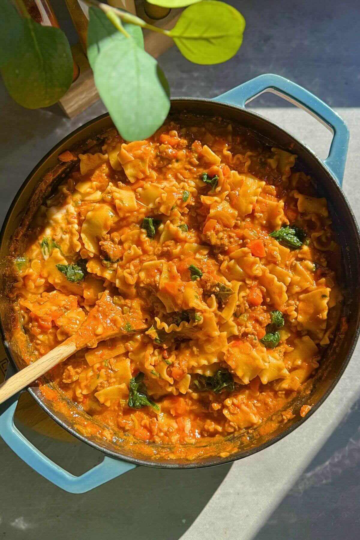 One-pan lazy lasagna with ricotta and fresh basil in a cast iron skillet