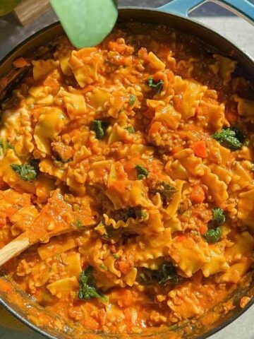 One-pan lazy lasagna with ricotta and fresh basil in a cast iron skillet.