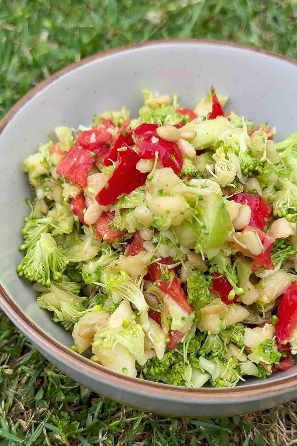 Crunchy broccoli apple salad with honey mustard dressing in a bowl.