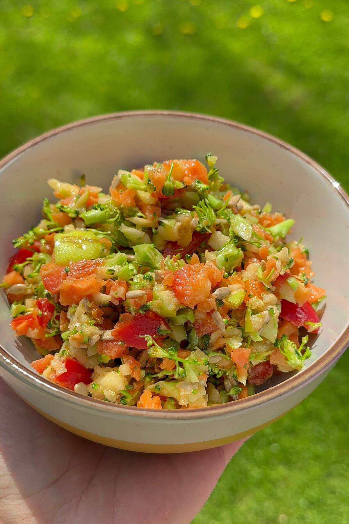 Bowl of raw broccoli salad no mayo with honey mustard vinaigrette.