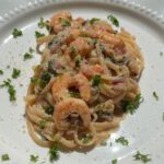One-pot shrimp linguine with lemon garlic butter and spinach in skillet.