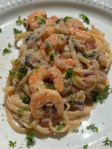 One-pot shrimp linguine with lemon garlic butter and spinach in skillet.