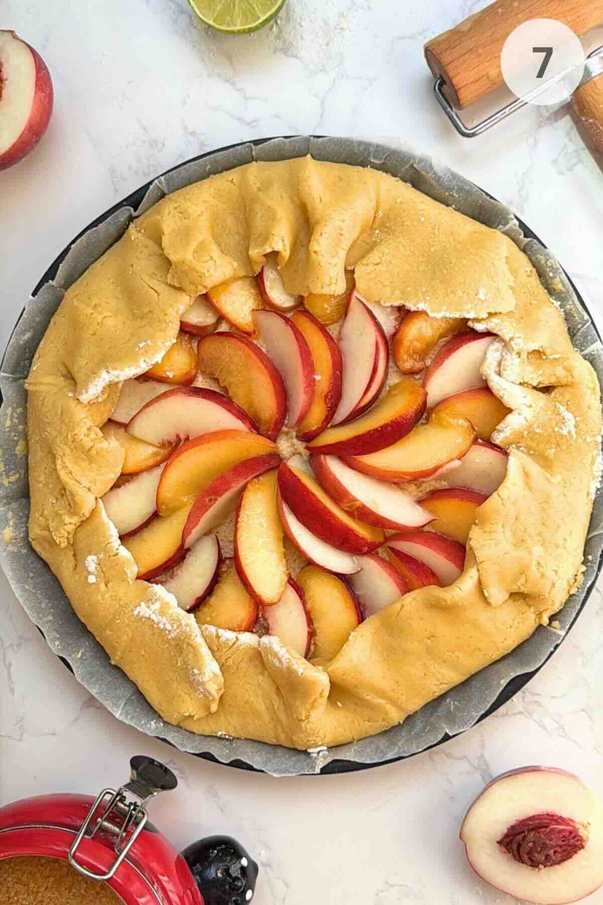 Displaying the assembled galette featuring egg-brushed crust sprinkled with demerara sugar.