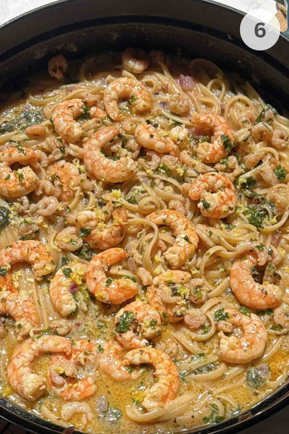 One-pot shrimp linguine with lemon garlic butter and spinach in skillet.