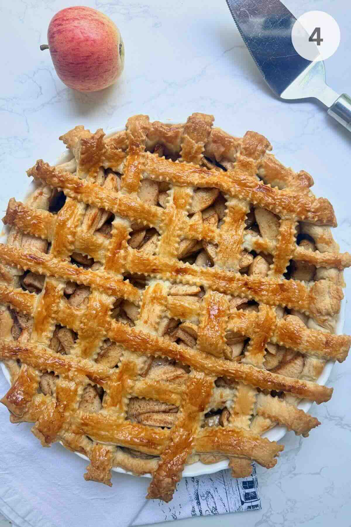 Golden baked puff pastry apple pie with lattice top.