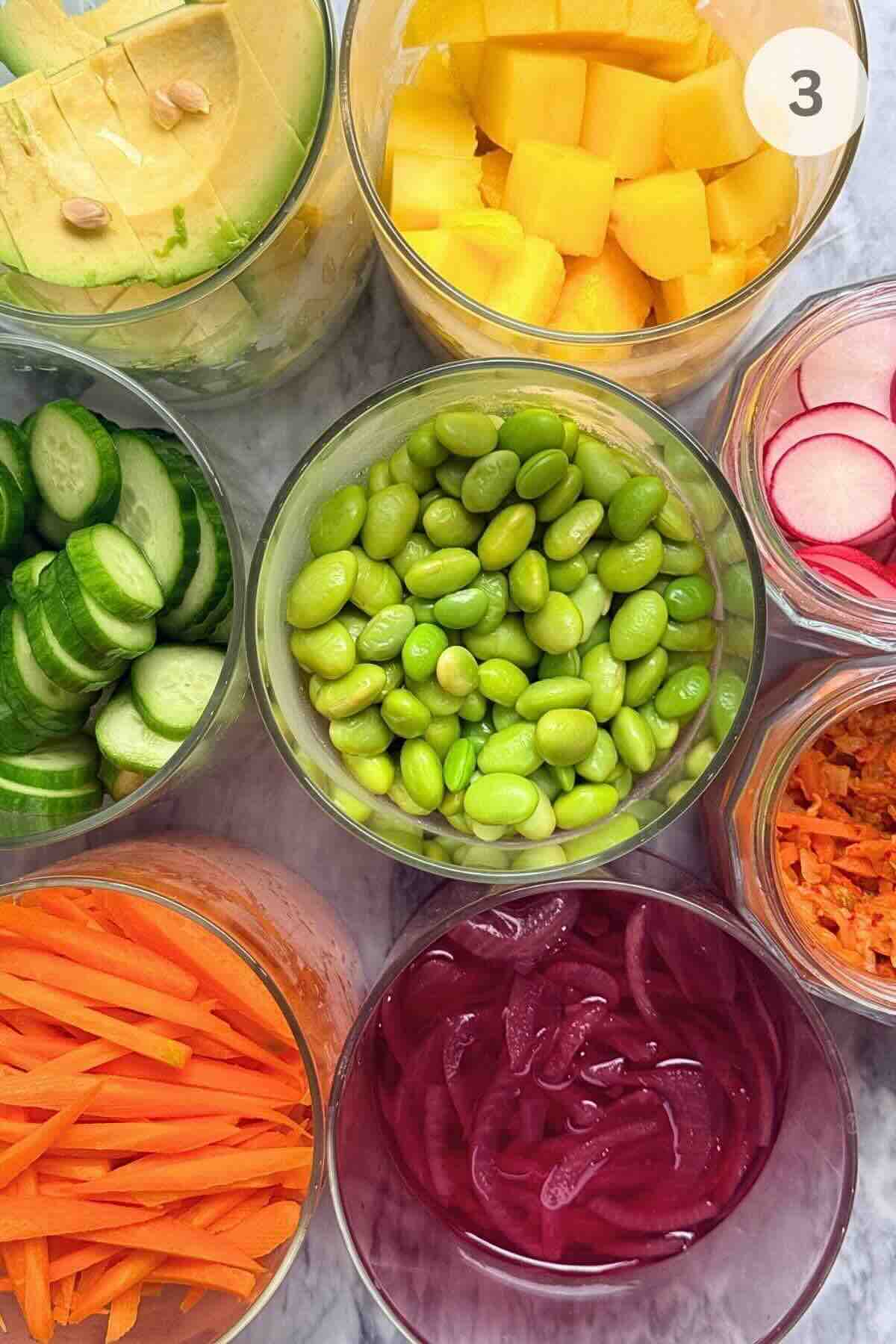 Ingredients for poke bowls including sushi rice, seared tuna, and colorful toppings.