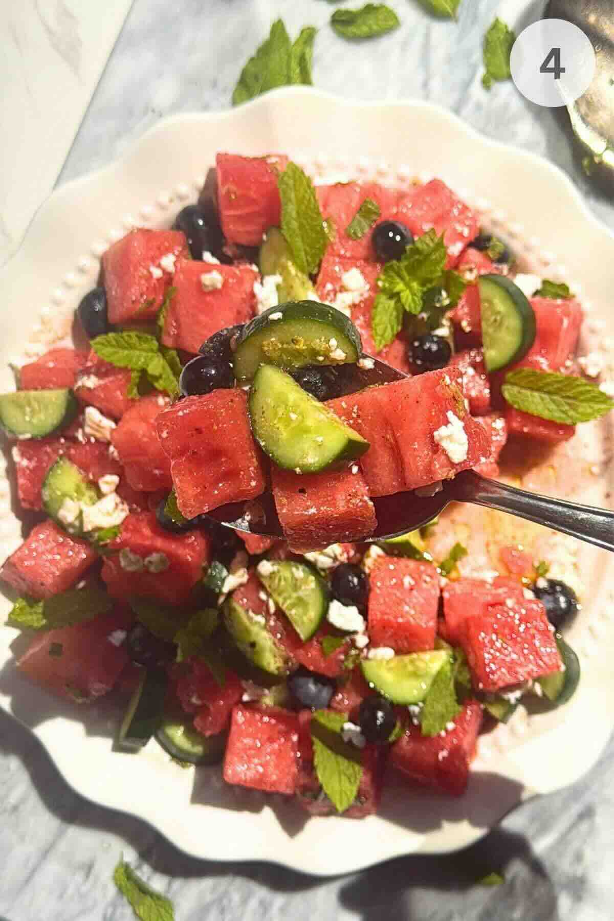 Watermelon cucumber feta salad tossed with lime dressing and fresh mint.