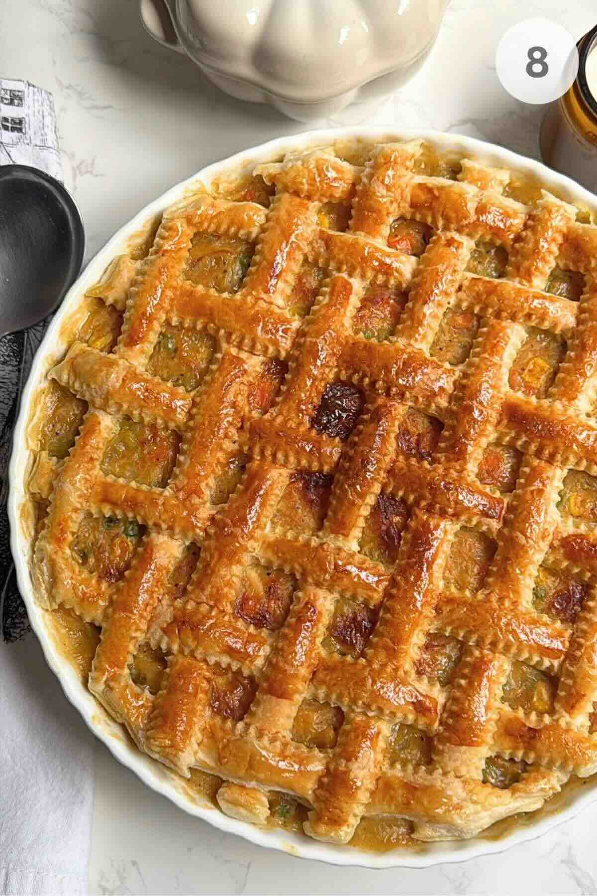 Baked puff pastry chicken pot pie with a golden, crisp braided crust.
