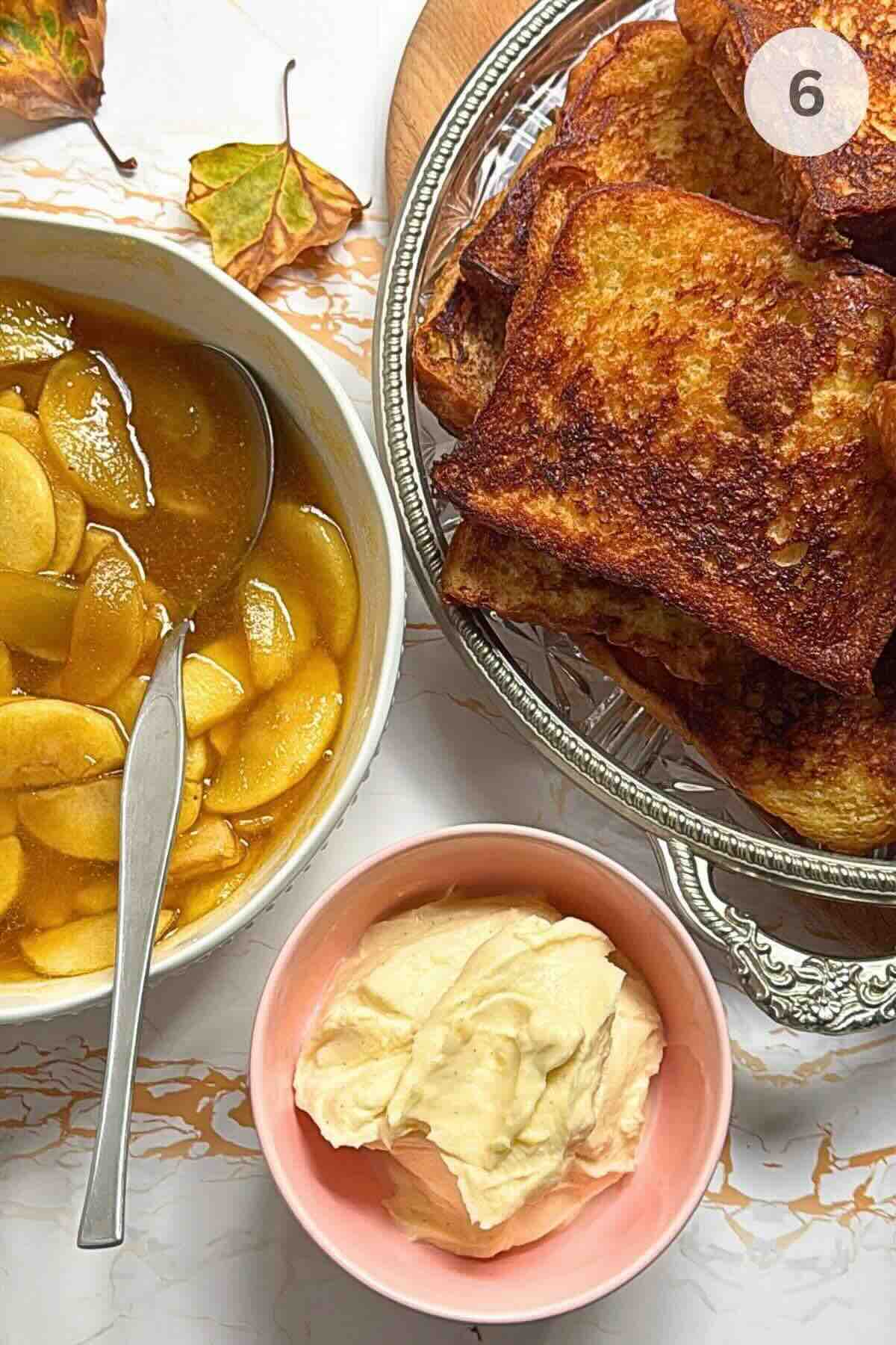 Brioche French toast plated, caramelized apples and whipped cream, ready to be served.