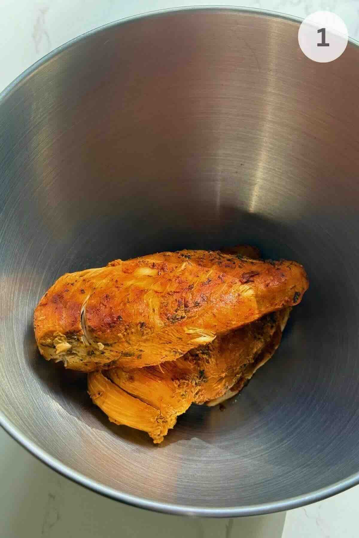 Cooked chicken breasts seasoned with salt, pepper, paprika, garlic powder, and thyme.