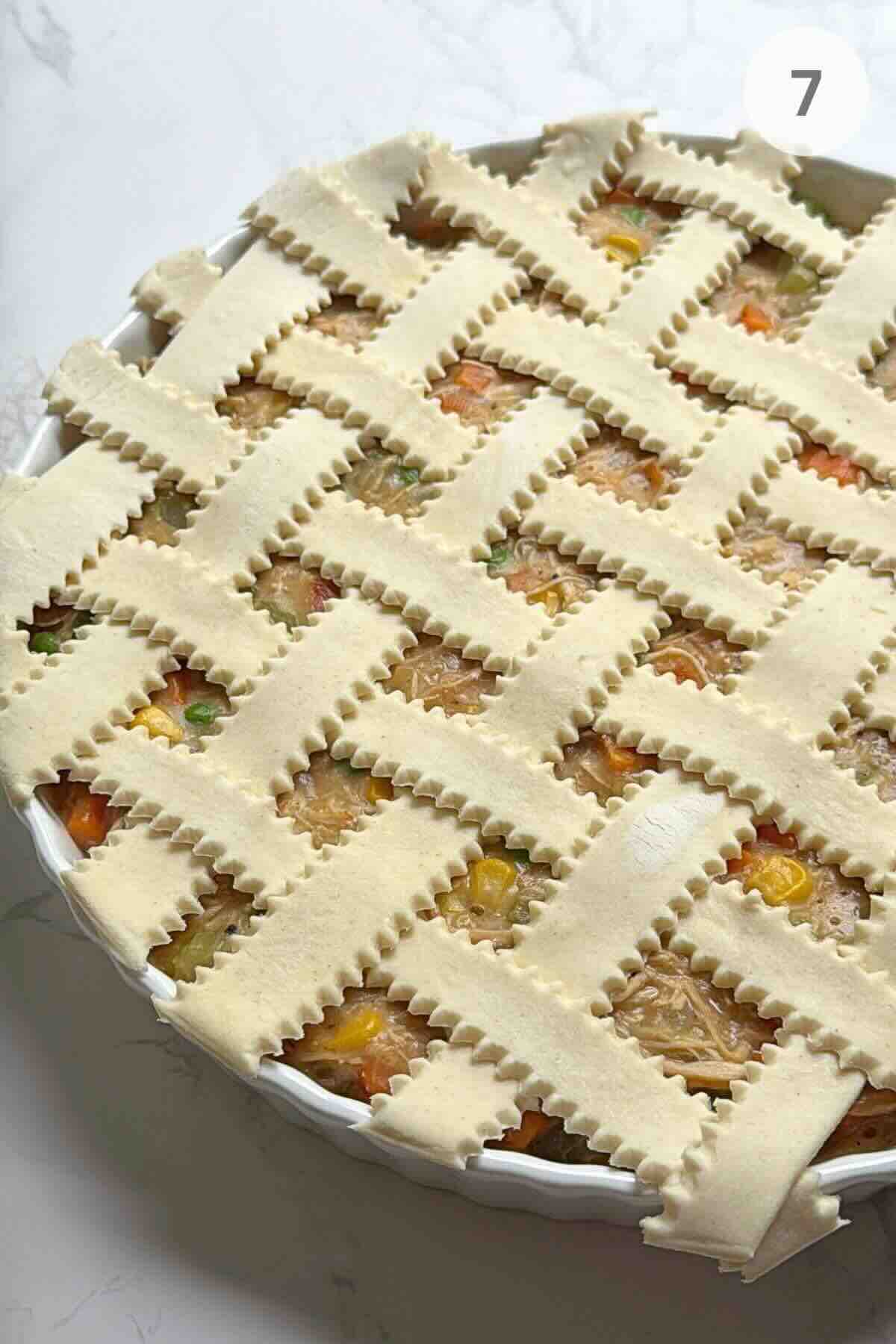 Puff pastry strips braided over the chicken pot pie filling before baking.