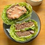 Big Mac lettuce wrap cut in half showing two beef patties, iceberg layers and special sauce.