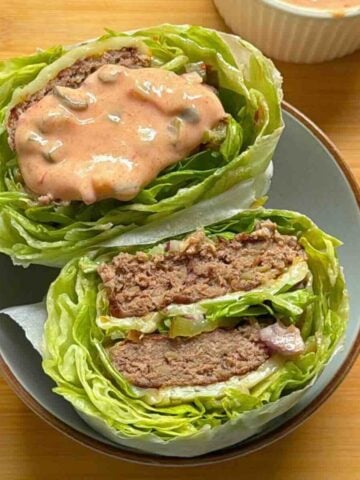 Big Mac lettuce wrap cut in half showing two beef patties, iceberg layers and special sauce.